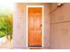 Close-up of a warm brown front door with the house number and natural sunlight at 15221 N Clubgate Dr # 2012, Scottsdale, AZ 85254