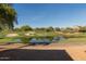 Picturesque golf course view featuring a pond surrounded by lush green grass and sand traps at 15221 N Clubgate Dr # 2012, Scottsdale, AZ 85254