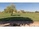 Scenic view of the lush green golf course with large building in the distance at 15221 N Clubgate Dr # 2012, Scottsdale, AZ 85254