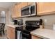 Modern kitchen featuring stainless steel appliances and light wood cabinetry at 15221 N Clubgate Dr # 2012, Scottsdale, AZ 85254