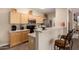 Open kitchen with light wood cabinets, stainless steel appliances, and a breakfast bar at 15221 N Clubgate Dr # 2012, Scottsdale, AZ 85254