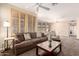Relaxing living space with a plush couch, a coffee table, and natural light from the window at 15221 N Clubgate Dr # 2012, Scottsdale, AZ 85254