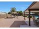 Large backyard with gravel, a patio cover, a gazebo, and pool, offering space for outdoor enjoyment at 15237 N 61St Dr, Glendale, AZ 85306