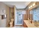 Well-appointed bathroom with tiled walk-in shower, toilet, and vanity with sink at 15237 N 61St Dr, Glendale, AZ 85306