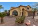 Landscaped front yard with desert plants and a rock lawn, leading to an inviting entrance at 15237 N 61St Dr, Glendale, AZ 85306
