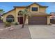 Charming home featuring desert landscaping, arched window, and a palm tree at 15237 N 61St Dr, Glendale, AZ 85306