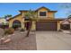 Charming home with a brown two-car garage and mature landscaping, including a palm tree at 15237 N 61St Dr, Glendale, AZ 85306