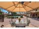 Under the gazebo with a view of the pool and backyard landscaping provides a relaxing outdoor space at 15237 N 61St Dr, Glendale, AZ 85306