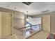 Spacious hallway with chandelier lighting provides access to bedrooms from the staircase at 15237 N 61St Dr, Glendale, AZ 85306