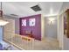 Second-floor hallway features a small seating area, soft carpeting, and stylish purple accent wall at 15237 N 61St Dr, Glendale, AZ 85306