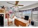 Bright home office with natural light, a ceiling fan, an executive chair, and unique wall art at 15237 N 61St Dr, Glendale, AZ 85306