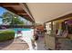 Relaxing covered patio area with a pool view and comfortable seating, perfect for outdoor living at 15237 N 61St Dr, Glendale, AZ 85306
