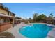 Inviting backyard pool area, complete with a hot tub, covered patio, and barbecue setup at 15237 N 61St Dr, Glendale, AZ 85306