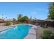 Secluded backyard pool featuring manicured landscaping, relaxing garden area, and a built-in hot tub at 15237 N 61St Dr, Glendale, AZ 85306