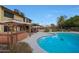 Backyard showcases a sparkling pool, hot tub, and multiple seating areas for outdoor entertainment at 15237 N 61St Dr, Glendale, AZ 85306