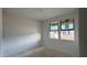 Well-lit bedroom with dual windows offering great natural light and an unfinished floor at 15764 W Beryl Ave, Waddell, AZ 85355
