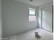 Unfinished bedroom with a window, neutral walls, and a closet with sliding doors at 15764 W Beryl Ave, Waddell, AZ 85355