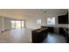Spacious open-concept kitchen and living area with tile floors and sliding glass doors at 15764 W Beryl Ave, Waddell, AZ 85355
