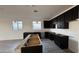 Open kitchen space with black cabinetry, an island, and modern recessed lighting at 15764 W Beryl Ave, Waddell, AZ 85355