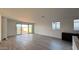 Open living room area with tile floors, modern recessed lighting, and access to the backyard at 15764 W Beryl Ave, Waddell, AZ 85355