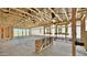 Spacious living room showcasing the home's unfinished framing and lots of natural light at 15764 W Beryl Ave, Waddell, AZ 85355