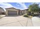 Charming single-Gathering home featuring a gray garage door and stone accents at 1605 W Molly Ln, Phoenix, AZ 85085