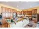 Kitchen island with granite countertop, stainless steel appliances, and custom cabinetry at 16086 W Cortez St, Surprise, AZ 85379