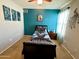 Vibrant bedroom with a striking blue accent wall and a ceiling fan at 16535 W Fillmore St, Goodyear, AZ 85338