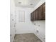 Laundry room with upper cabinets, a window, and washer/dryer hookups at 1783 W Homestead Dr, Chandler, AZ 85286