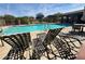 Community pool with lounge chairs and shaded seating under a blue, cloudy sky at 1783 W Homestead Dr, Chandler, AZ 85286