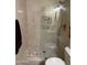 Modern tiled walk-in shower with updated fixtures, a built-in toiletry shelf and clean glass partition at 19224 N 93Rd Ave, Peoria, AZ 85382