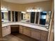 Bathroom vanity featuring granite countertops, ample mirror space, and abundant storage at 19224 N 93Rd Ave, Peoria, AZ 85382