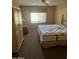 Neutral bedroom featuring a large window for natural light, a ceiling fan, and an accent wardrobe at 19224 N 93Rd Ave, Peoria, AZ 85382