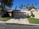Charming home featuring a 2-car garage, desert landscaping, and beautiful palm trees against a clear blue sky at 19224 N 93Rd Ave, Peoria, AZ 85382