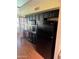 Modern kitchen featuring dark cabinets, granite countertops, and black appliances at 19224 N 93Rd Ave, Peoria, AZ 85382