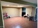 Spacious, light-filled living room with hardwood floors, a custom display cabinet, and open flow to other areas at 19224 N 93Rd Ave, Peoria, AZ 85382