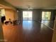 Open-concept living room boasts hardwood floors, natural light, and access to the backyard through sliding glass doors at 19224 N 93Rd Ave, Peoria, AZ 85382