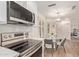 View from kitchen featuring stainless steel range and dining area with contemporary lighting at 19400 N Westbrook Pkwy # 241, Peoria, AZ 85382