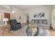Bright living room with hardwood floors, comfortable seating, and a stylish rug at 19400 N Westbrook Pkwy # 241, Peoria, AZ 85382
