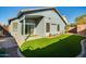 Inviting backyard featuring artificial turf, a covered patio, and mature plants near perimeter at 2145 E Danbury Rd, Phoenix, AZ 85022