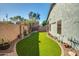 Beautiful backyard featuring a well-kept lawn, complemented by desert landscaping and a charming brick border at 2145 E Danbury Rd, Phoenix, AZ 85022