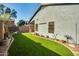 Backyard with artificial turf and mature plants on a well-maintained corner lot at 2145 E Danbury Rd, Phoenix, AZ 85022