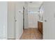 Hallway view of bathroom with tile floors, vanity, and walk-in shower at 2145 E Danbury Rd, Phoenix, AZ 85022