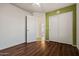 Bedroom with hardwood floor, ceiling fan, closet with sliding doors, and painted accent wall at 2145 E Danbury Rd, Phoenix, AZ 85022