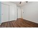 This bedroom features wood floors, a closet, and a white door to the hallway at 2145 E Danbury Rd, Phoenix, AZ 85022