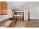 Bright kitchen boasts stainless steel appliances, tile flooring, and ample wood cabinets at 2145 E Danbury Rd, Phoenix, AZ 85022