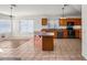 Spacious kitchen with wood cabinetry, breakfast bar, tile flooring, and room for entertaining at 2145 E Danbury Rd, Phoenix, AZ 85022
