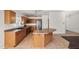 Well-lit kitchen features stainless appliances, wood cabinets, tile flooring, and a breakfast bar at 2145 E Danbury Rd, Phoenix, AZ 85022