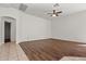 Bright and airy living room showcasing a ceiling fan, white walls, and hard wood floors at 2145 E Danbury Rd, Phoenix, AZ 85022