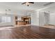 Spacious open-concept living area featuring hardwood floors, a ceiling fan, and an open kitchen at 2145 E Danbury Rd, Phoenix, AZ 85022